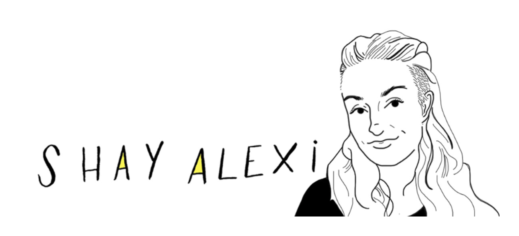 Shay's name (Shay Alexi) is hand drawn. The inner portion of the A's is colored bright yellow. Next to the text is an illustration of Shay. She is a white person with long wavy brown hair and an undercut.